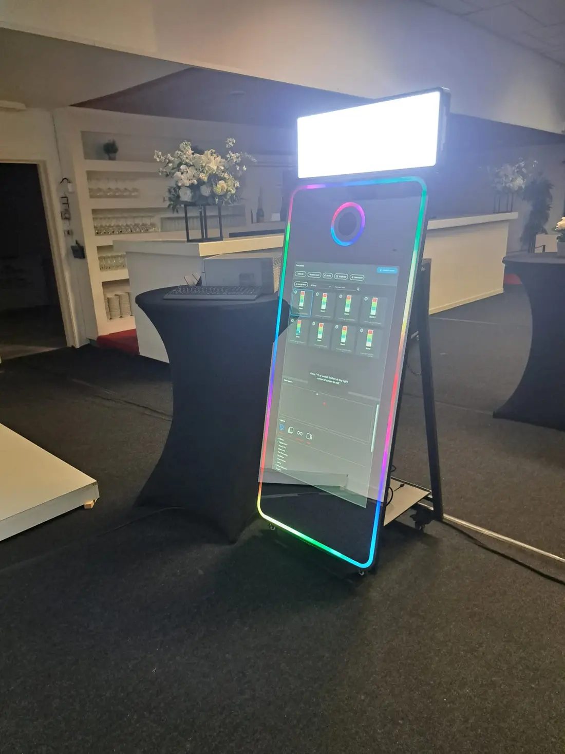 De GlamMirror, een manshoge spiegel met gekleurde LED-verlichting rondom, in een feestzaal.